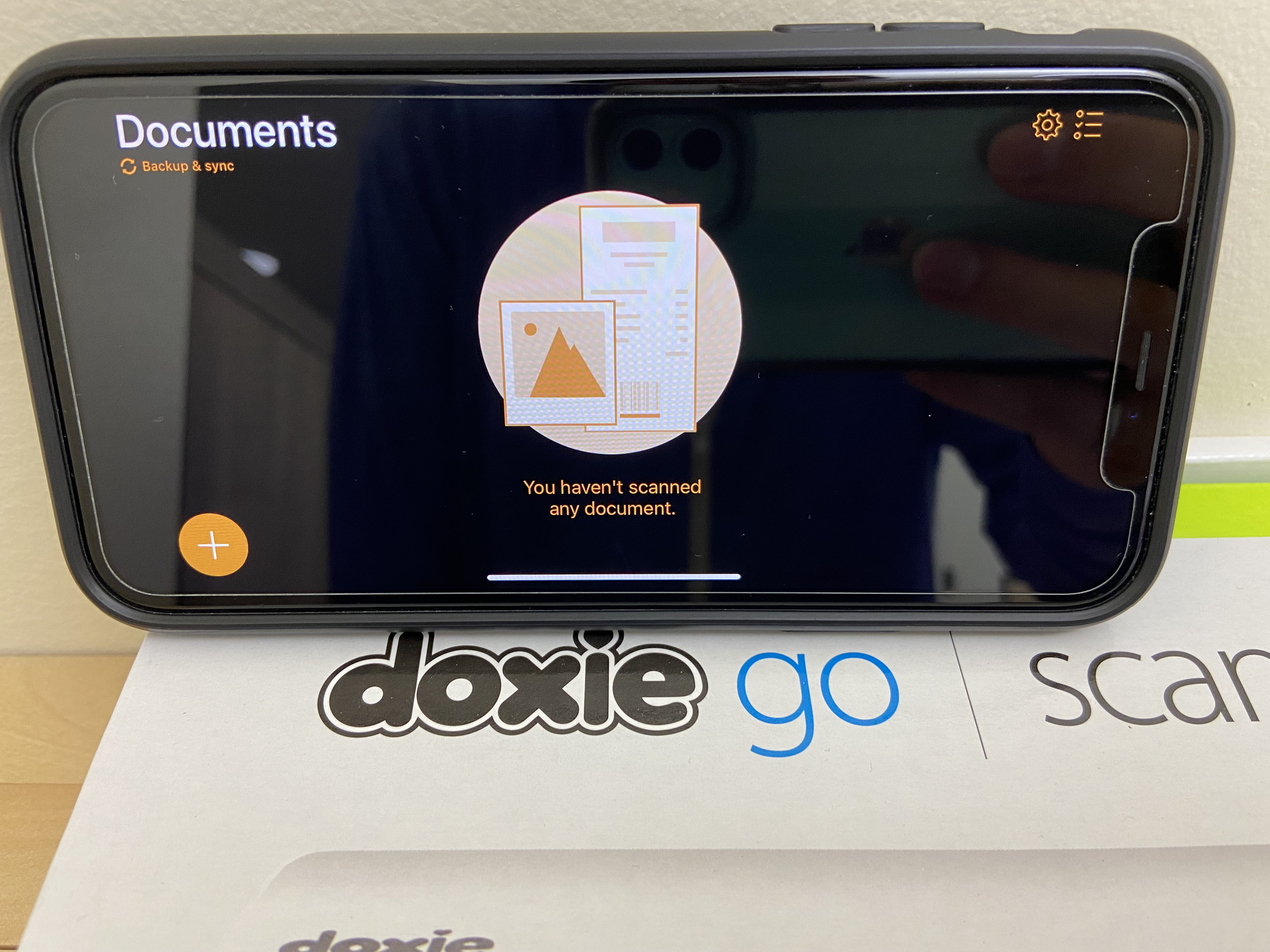 'My Doxie Go Scanner box with my iPhone 11 showing the Genius Scan application'